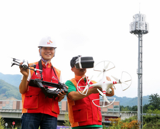 SK텔레콤은 산간오지와 고도가 높은 지역의 고속도로, 철도 신설 지역 등 사람이 직접 현장 상황을 측정하기 힘든 지역에 드론을 투입해 더욱 정밀하고 효율적으로 이동통신 기지국을 설치하고 있다고 26일 밝혔다.회사 직원들이 강원도 원주지역 현장에서 드론을 이용해 이동통신 기지국 신설을 위한 측정 작업을 진행하고 있다.  SK텔레콤 제공